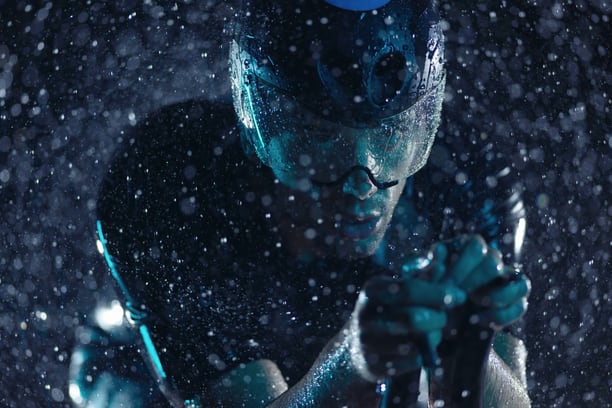 Triathlete in cycling gear — peak-moment sport photography